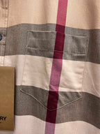 Burberry plaid chest pocket on beige check button-up shirt close-up