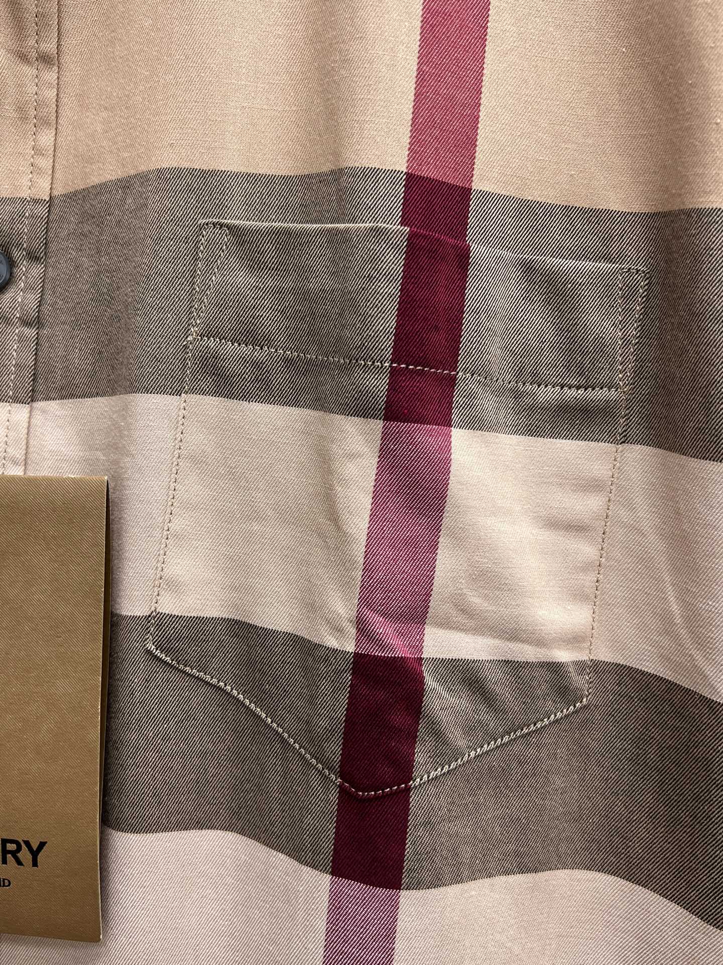 Burberry plaid chest pocket on beige check button-up shirt close-up
