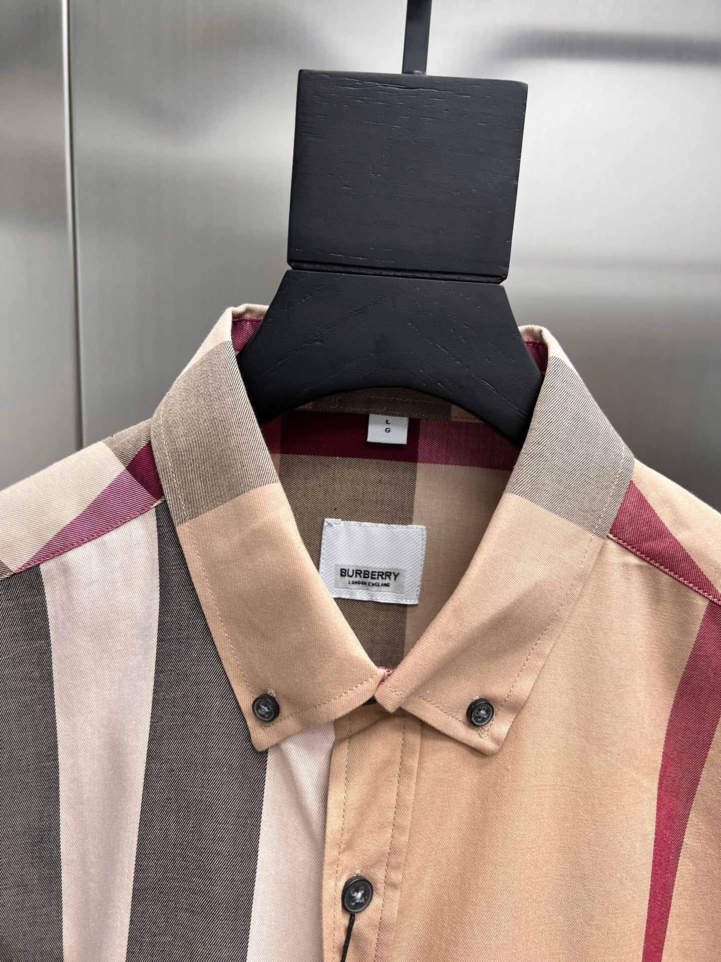 Burberry check button-up shirt collar detail with beige plaid and dark button placket