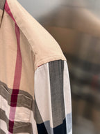Burberry plaid button-up shirt with beige body and navy/white side stripe panel