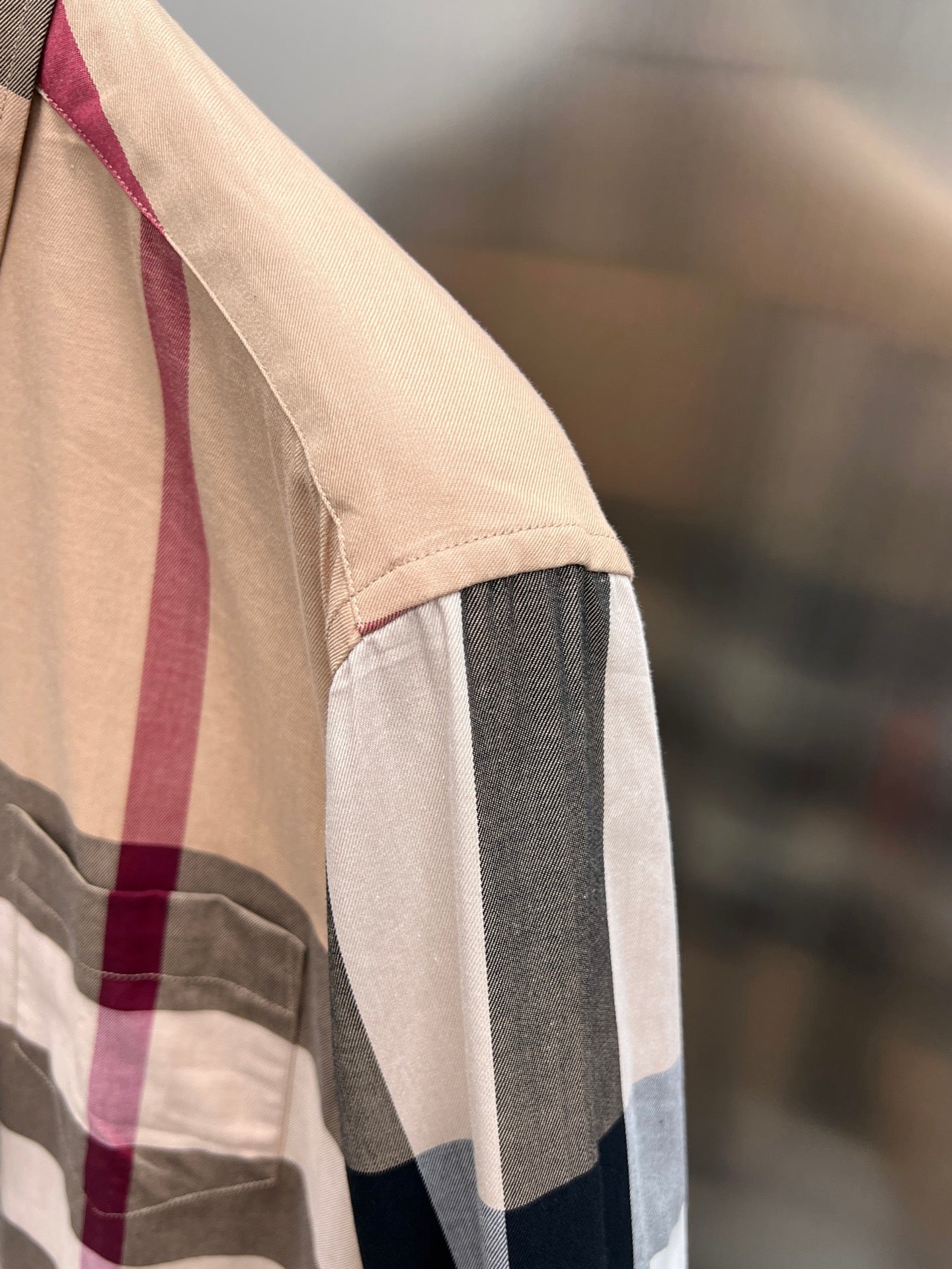 Burberry plaid button-up shirt with beige body and navy/white side stripe panel