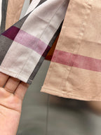 Burberry plaid cuff and sleeve hem on beige check button-up shirt close-up