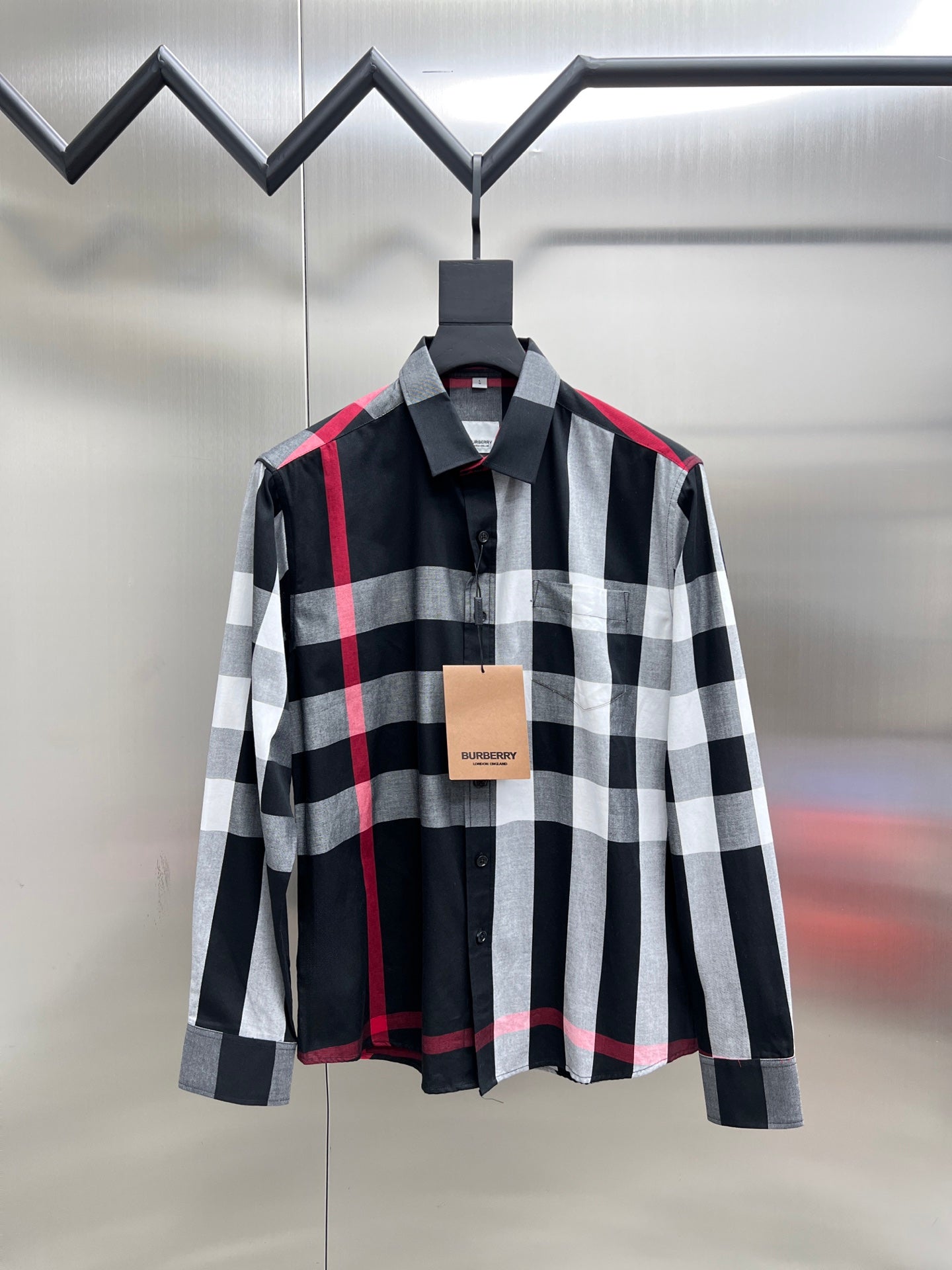 Black, white, and red plaid long-sleeve button-up shirt with pointed collar