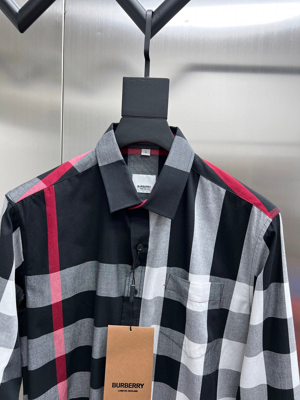 Plaid button-up shirt with pointed collar in black, white, and red checks