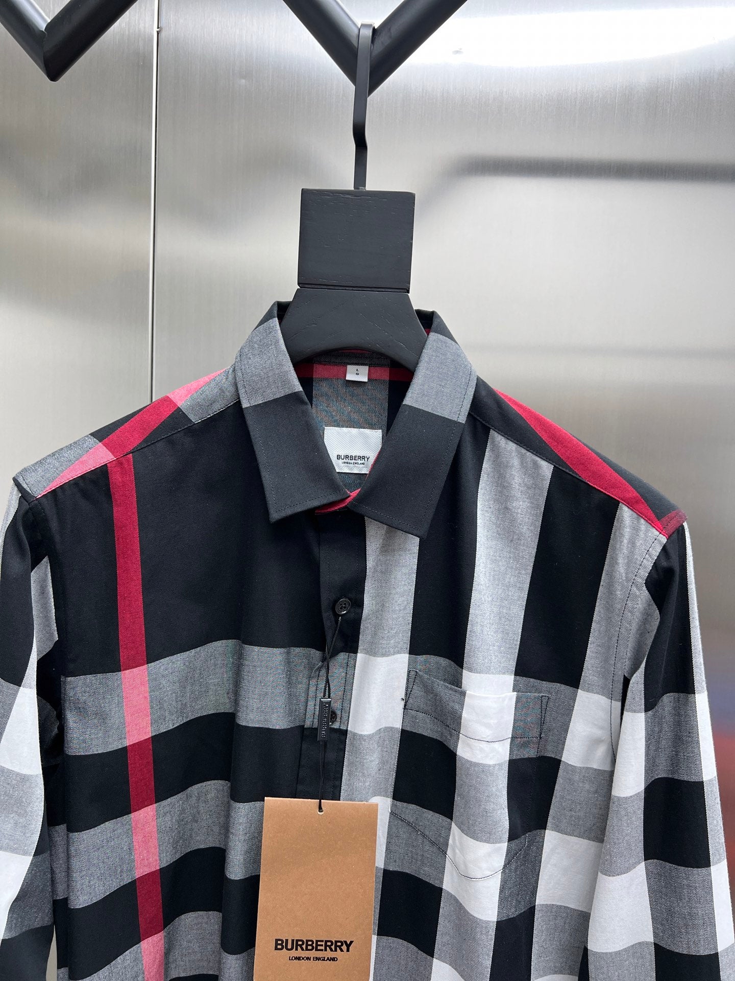 Plaid button-up shirt with pointed collar in black, white, and red checks