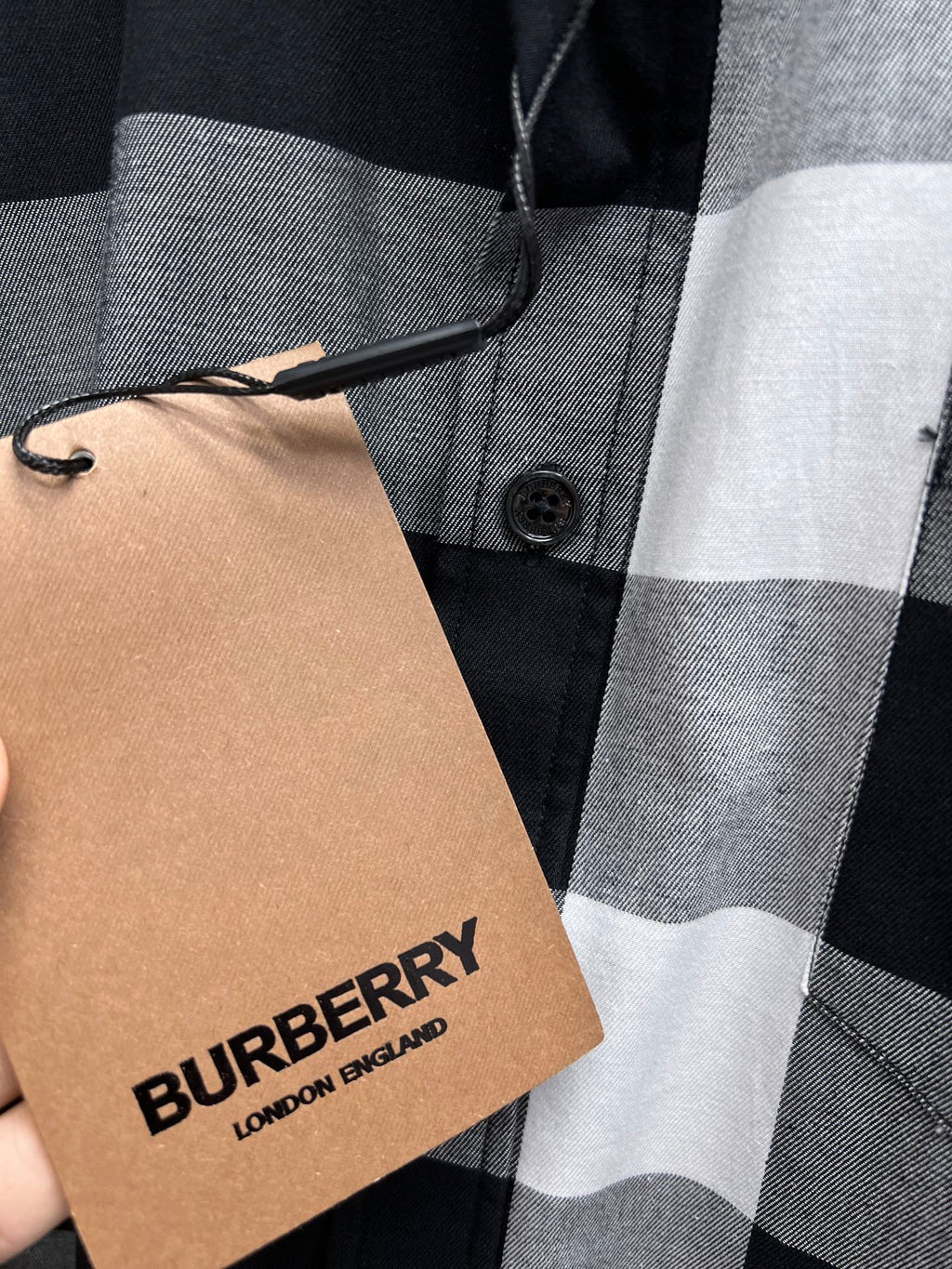 Black-and-white plaid button-up shirt with Burberry-branded hang tag