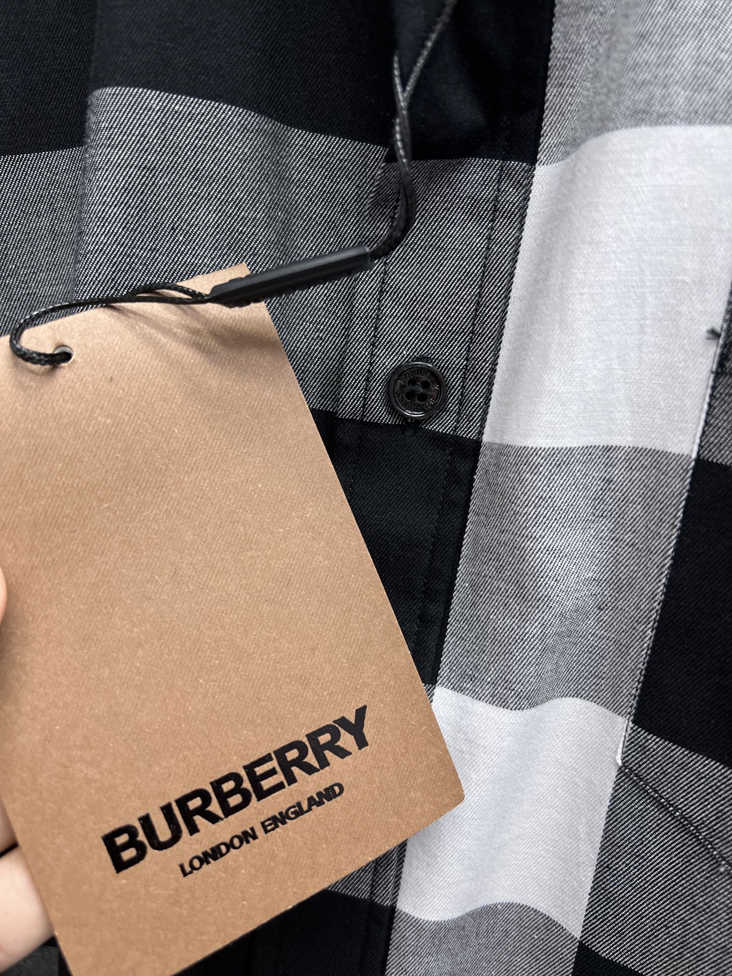 Black-and-white plaid button-up shirt with Burberry-branded hang tag