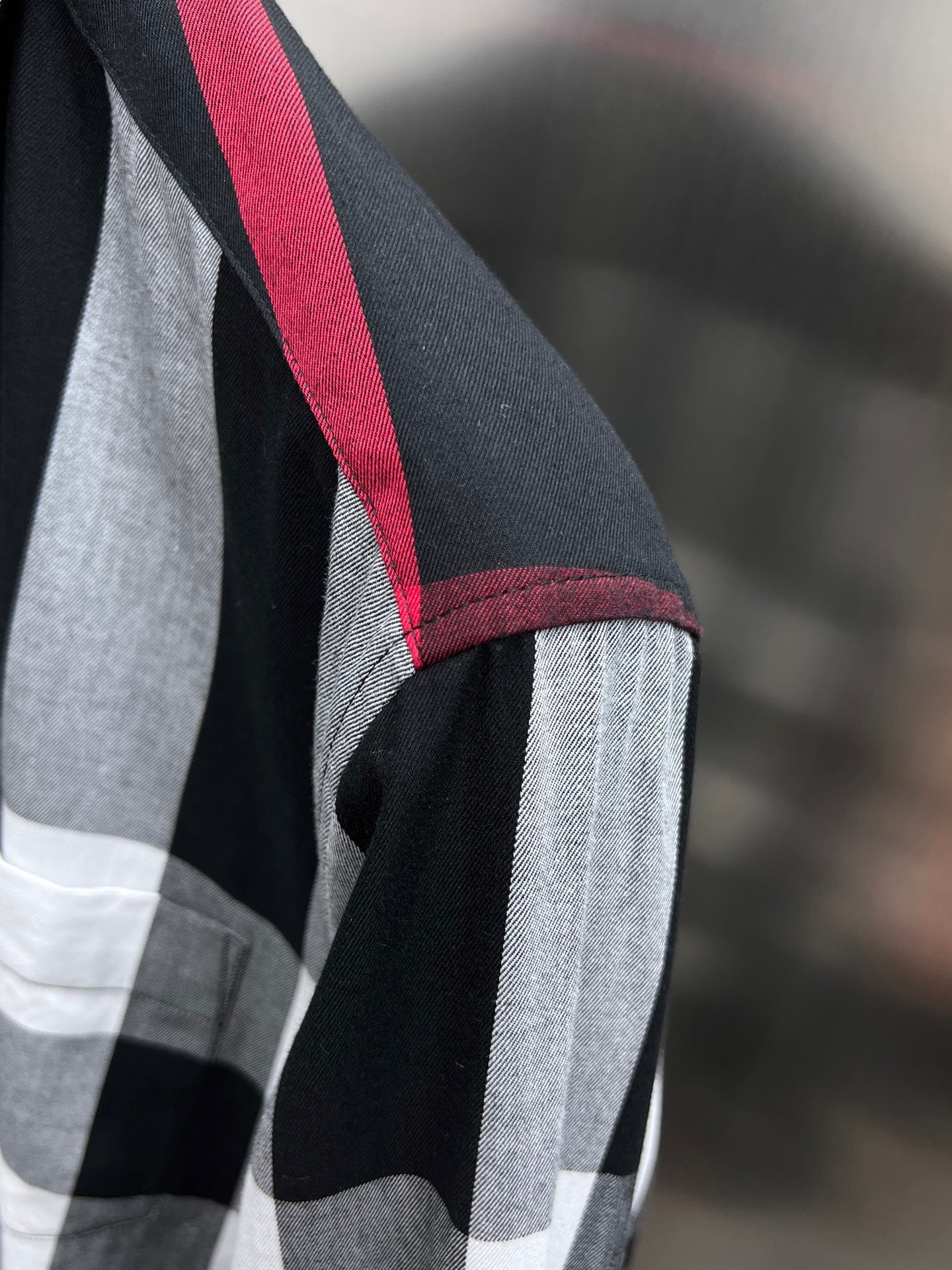 Plaid long-sleeve shirt with red-trimmed seam and black-and-white check pattern