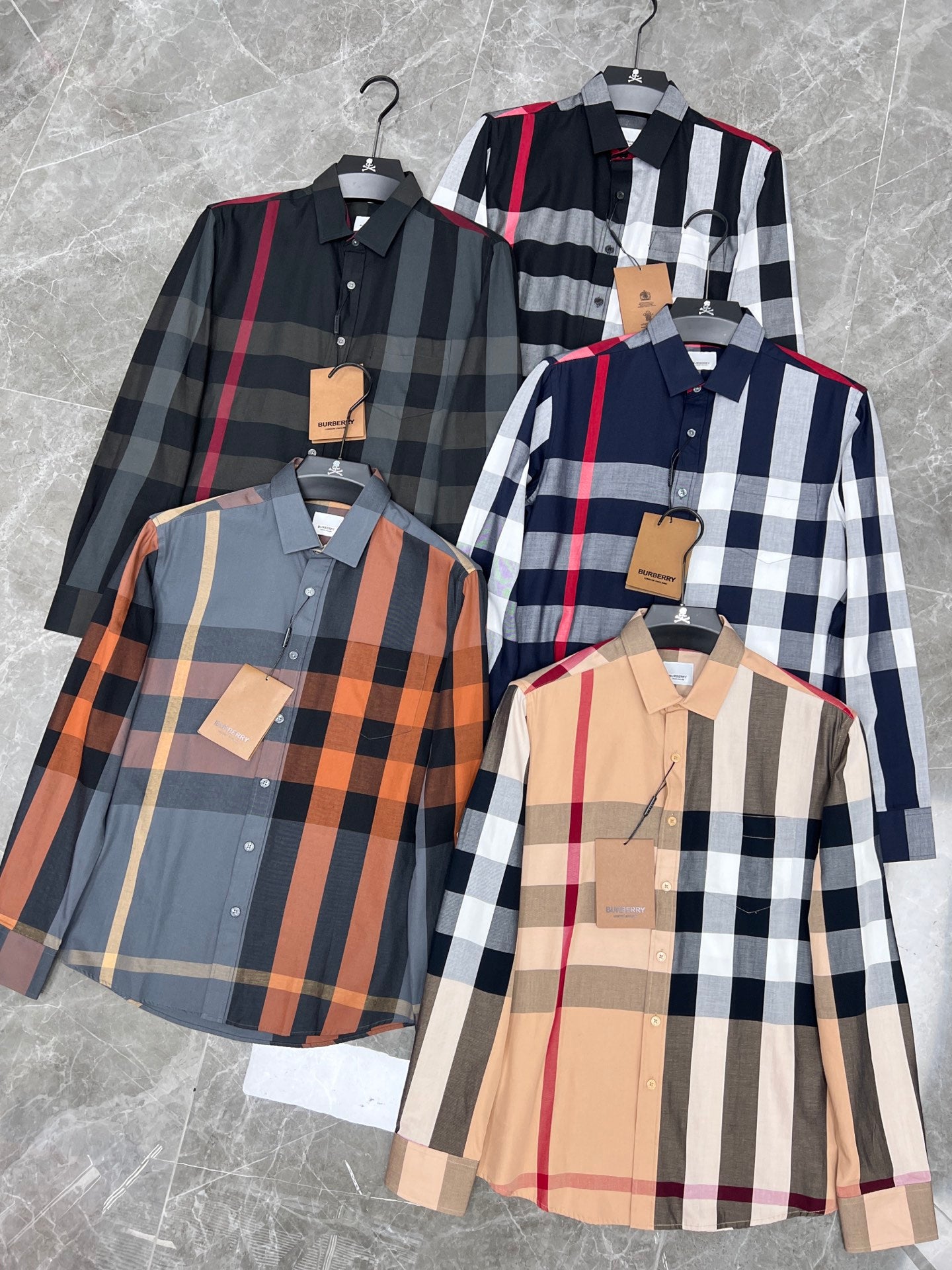 Plaid long-sleeve button-up shirts in black/white/red, orange, tan, and navy colorways