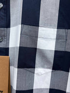 Burberry plaid shirt front pocket detail in navy, white, and gray checks