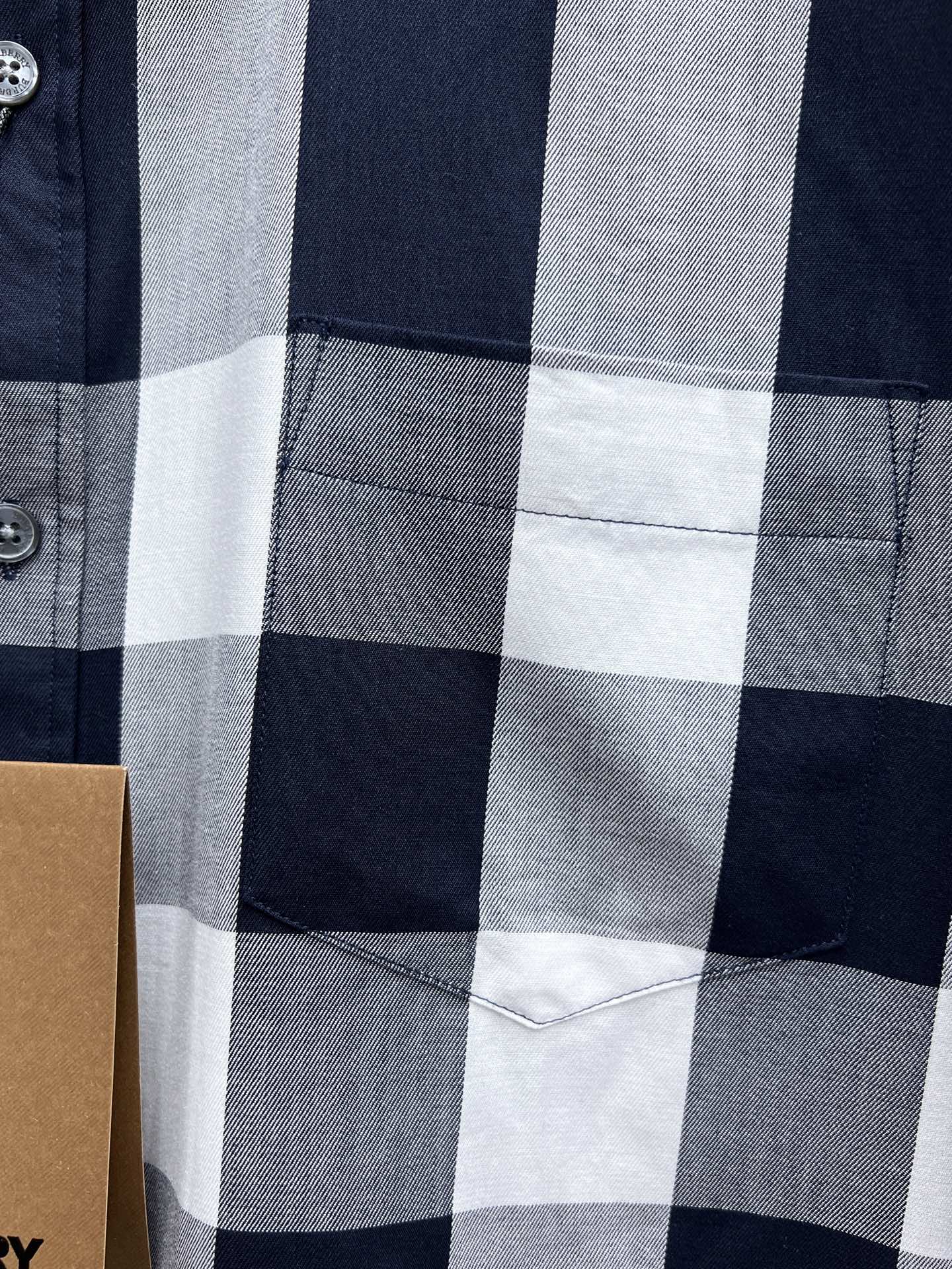 Burberry plaid shirt front pocket detail in navy, white, and gray checks