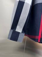 Burberry plaid shirt hem with navy, white, and red panels