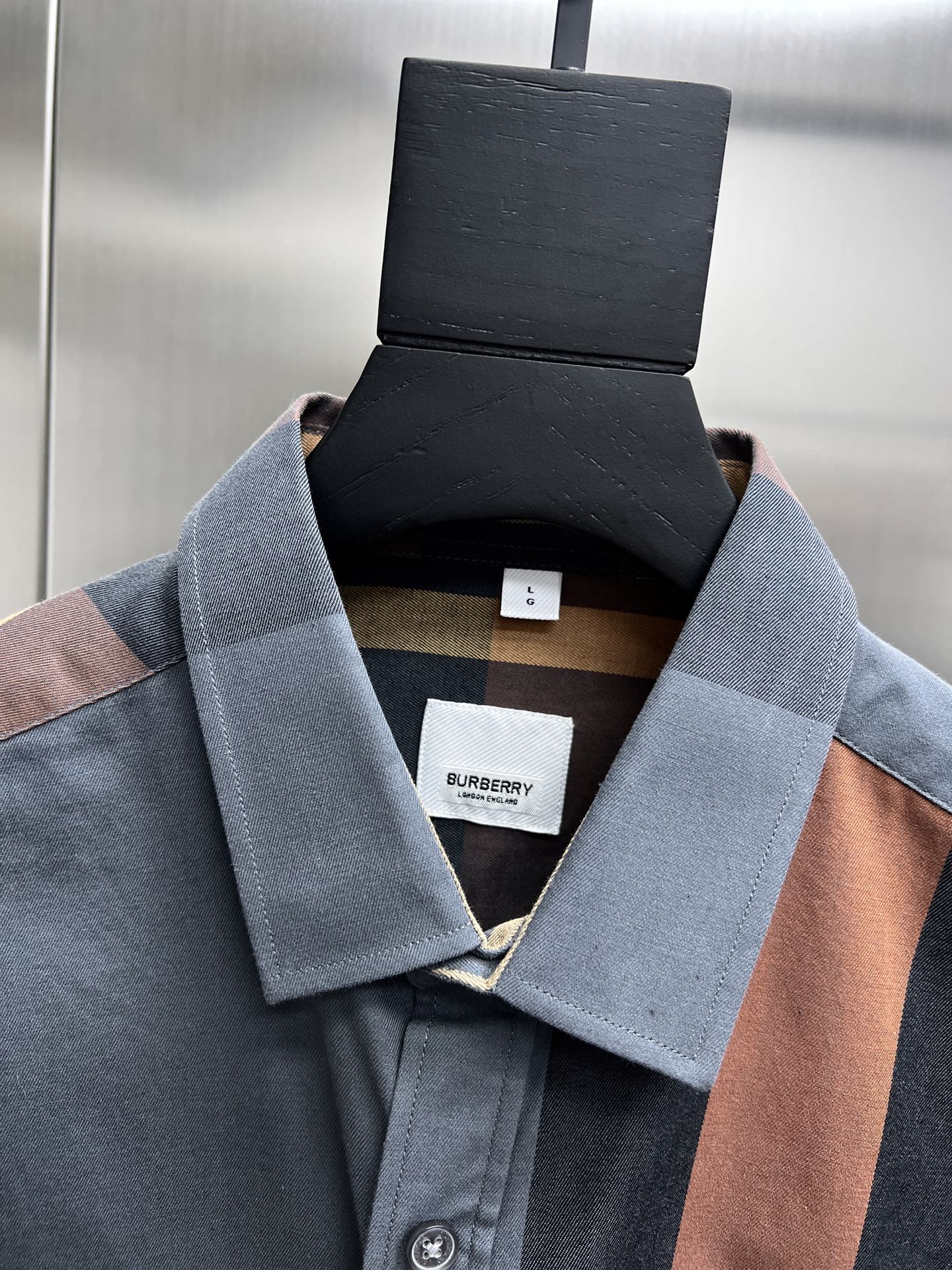 Plaid long-sleeve shirt close-up of collar and inner label with button placket