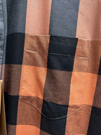 Plaid long-sleeve shirt pocket detail with tan-brown check and contrast stitching