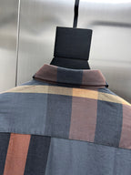 Long-sleeve shirt with blue, beige, and rust plaid paneling and folded collar