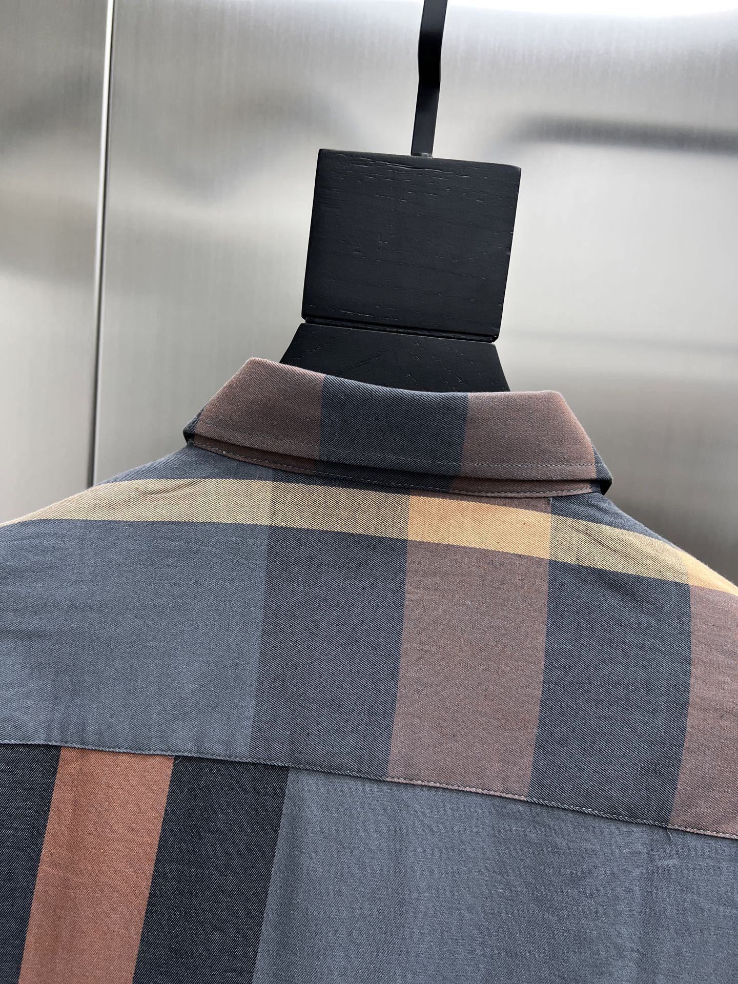 Long-sleeve shirt with blue, beige, and rust plaid paneling and folded collar