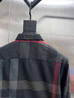 Dark plaid long-sleeve shirt with shoulder yoke and buttoned collar