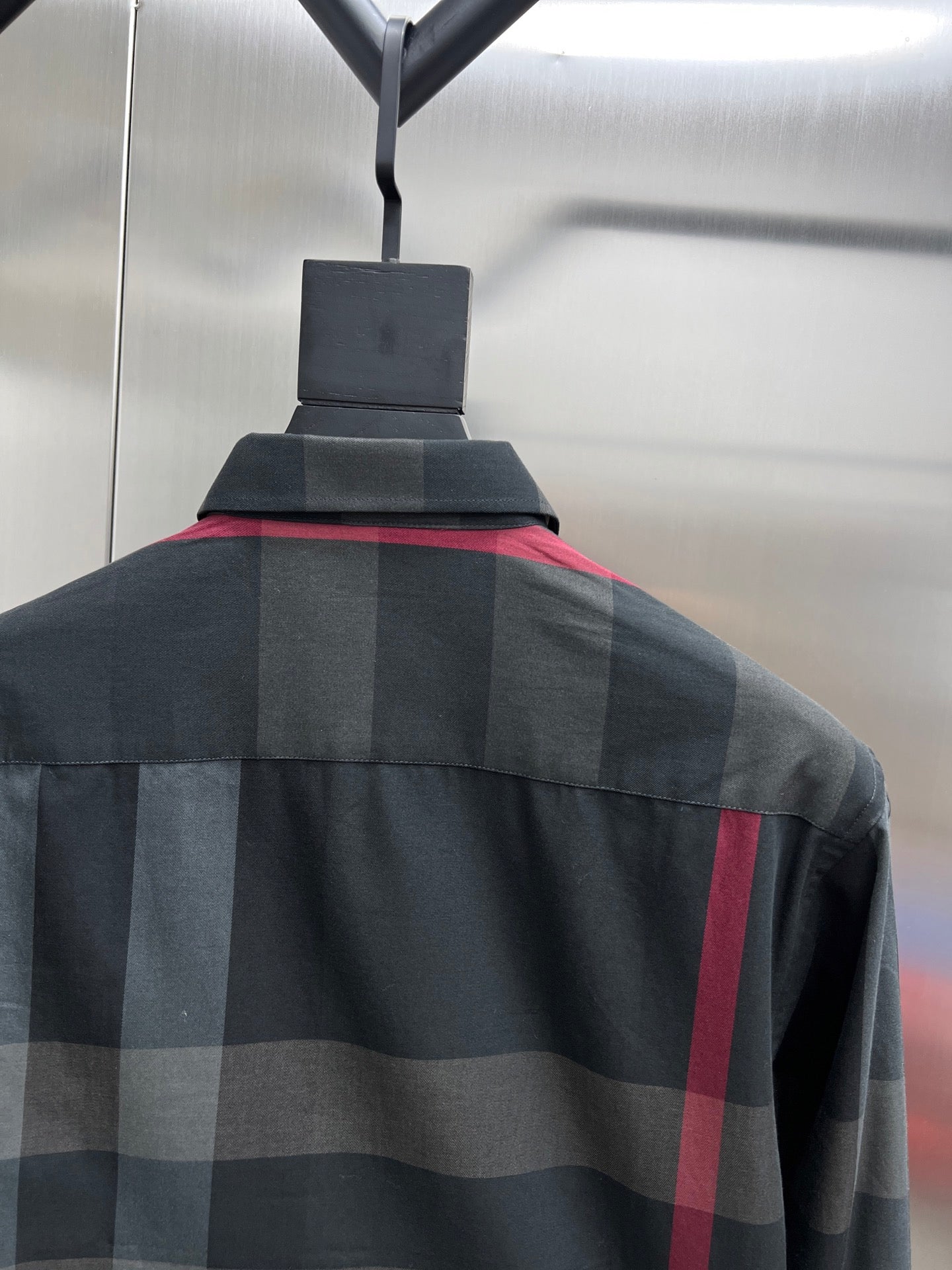 Dark plaid long-sleeve shirt with shoulder yoke and buttoned collar