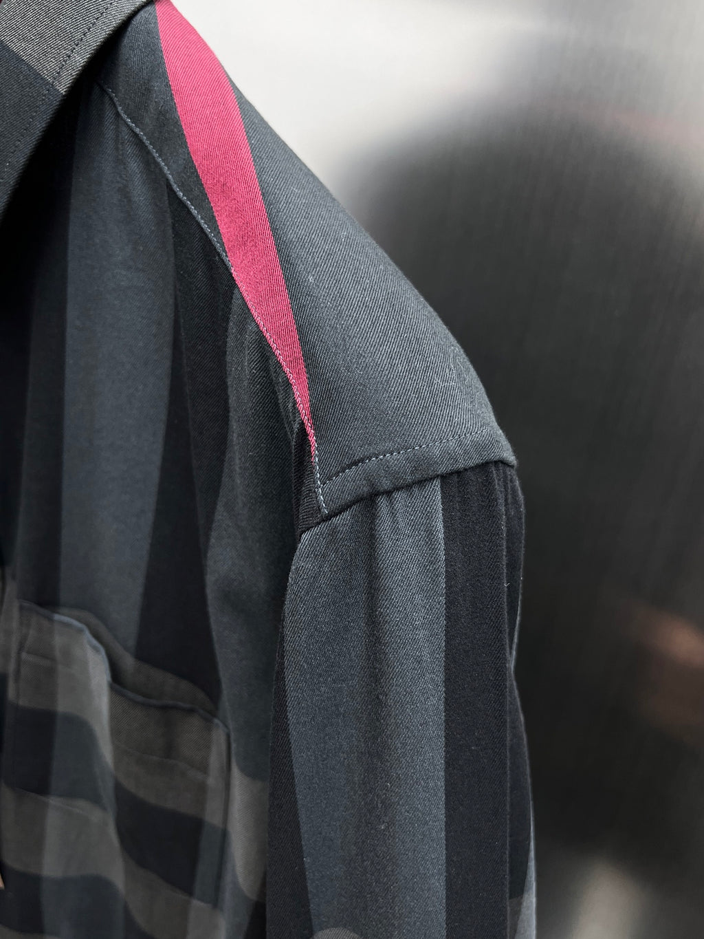 Burberry plaid button-up shirt sleeve with vertical red accent stripe