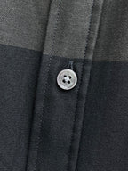 Burberry plaid button-up shirt button close-up, dark gray fabric
