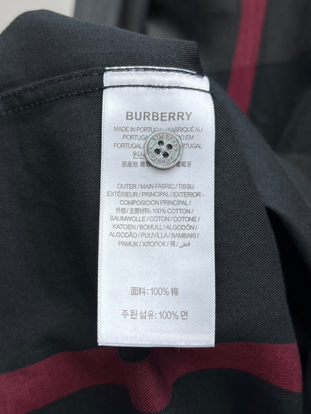 Burberry care label on dark plaid long-sleeve shirt, 100% cotton