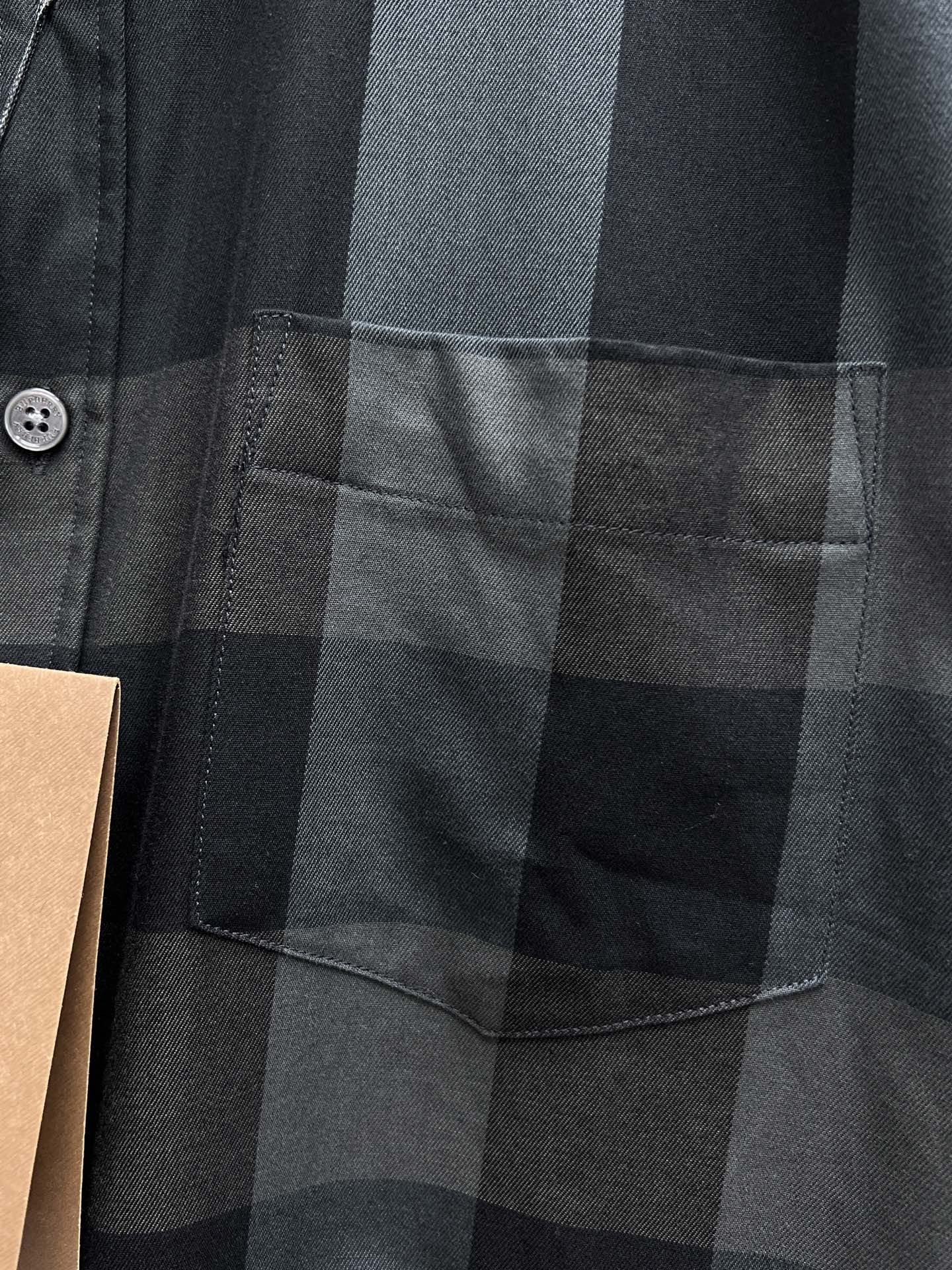 Burberry plaid button-up shirt chest pocket close-up, dark gray plaid