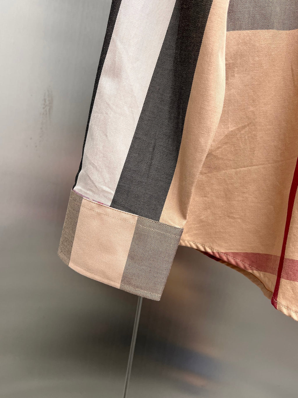 Burberry plaid long-sleeve shirt hem with beige, gray, and navy blocks
