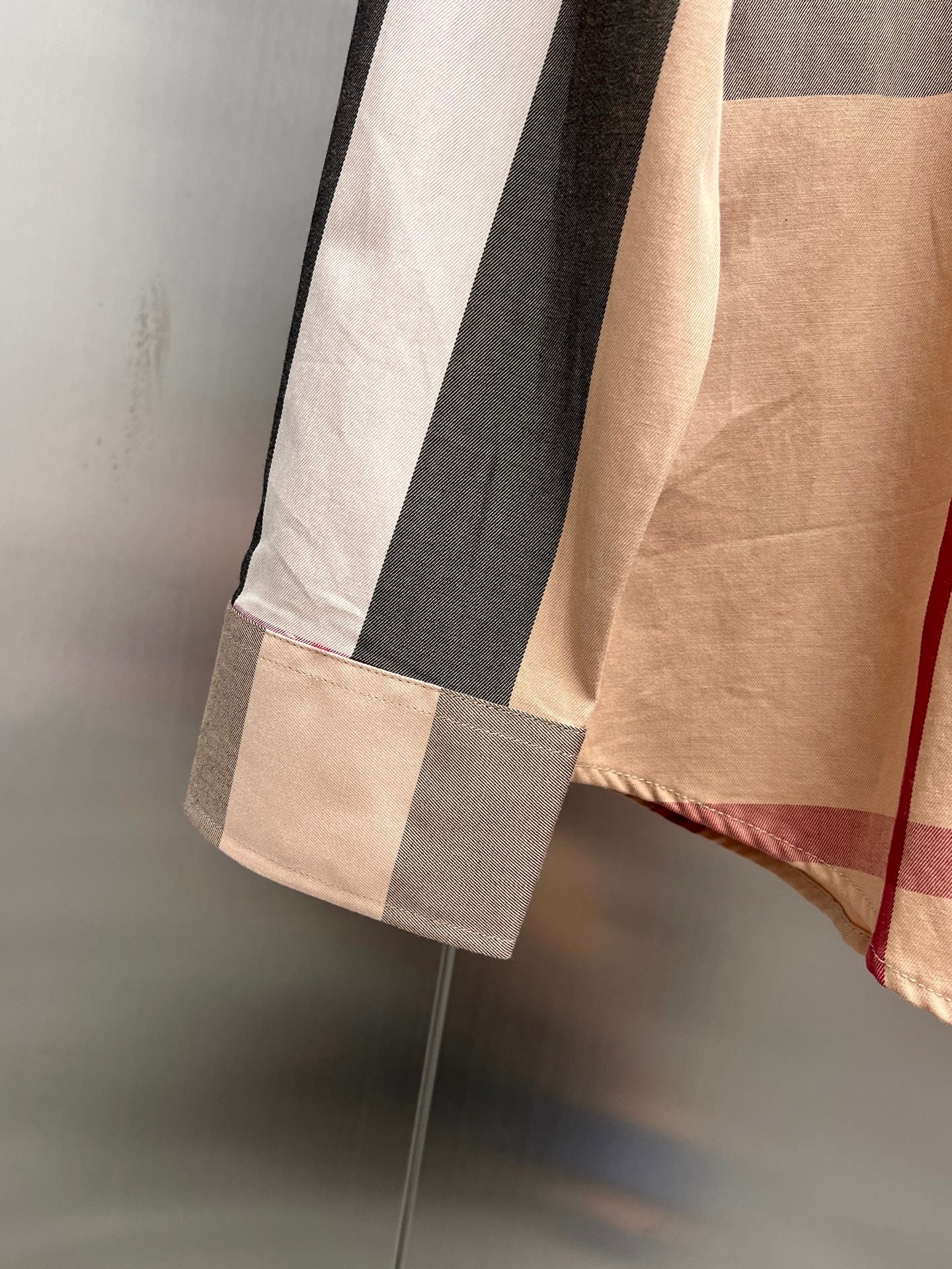 Burberry plaid long-sleeve shirt hem with beige, gray, and navy blocks