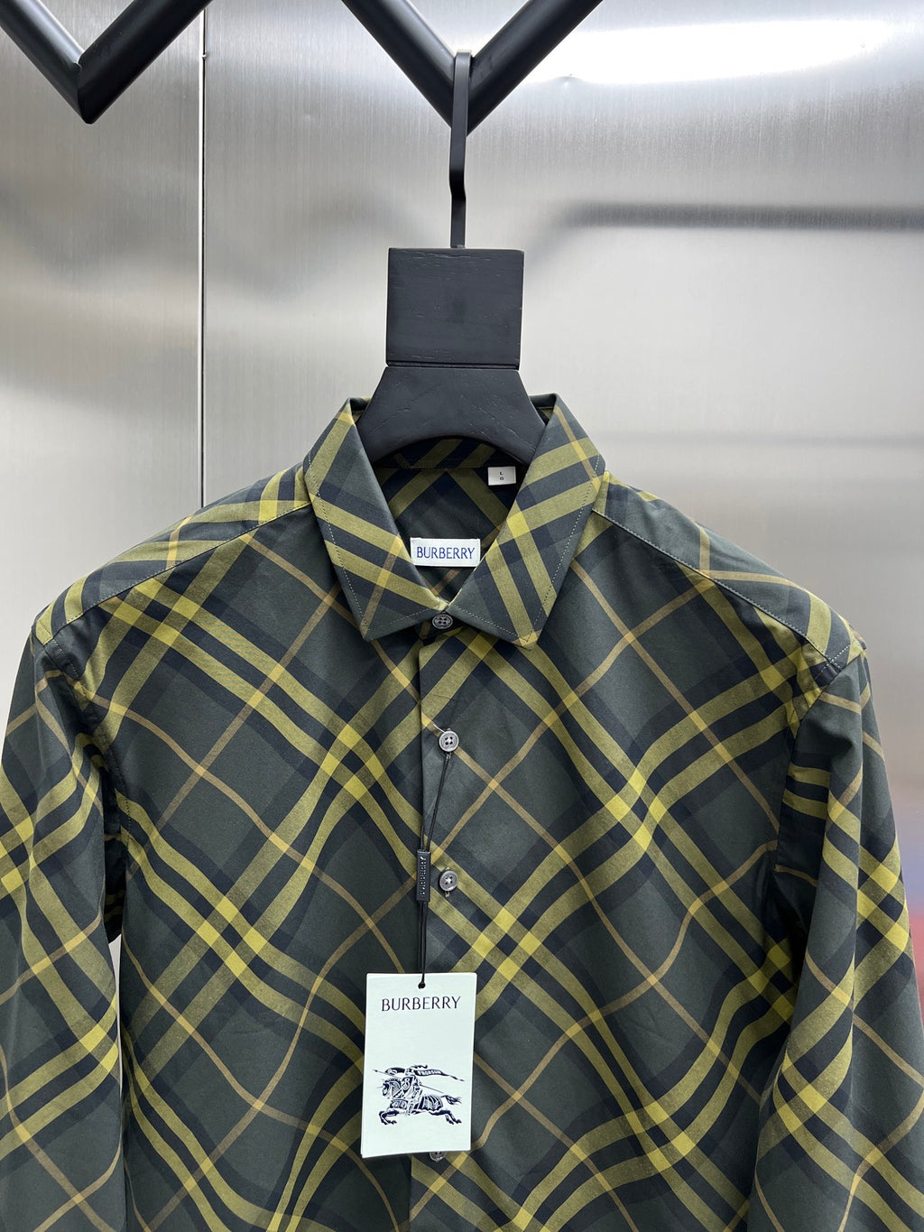 Plaid long-sleeve button-up shirt with pointed collar and chest logo tag