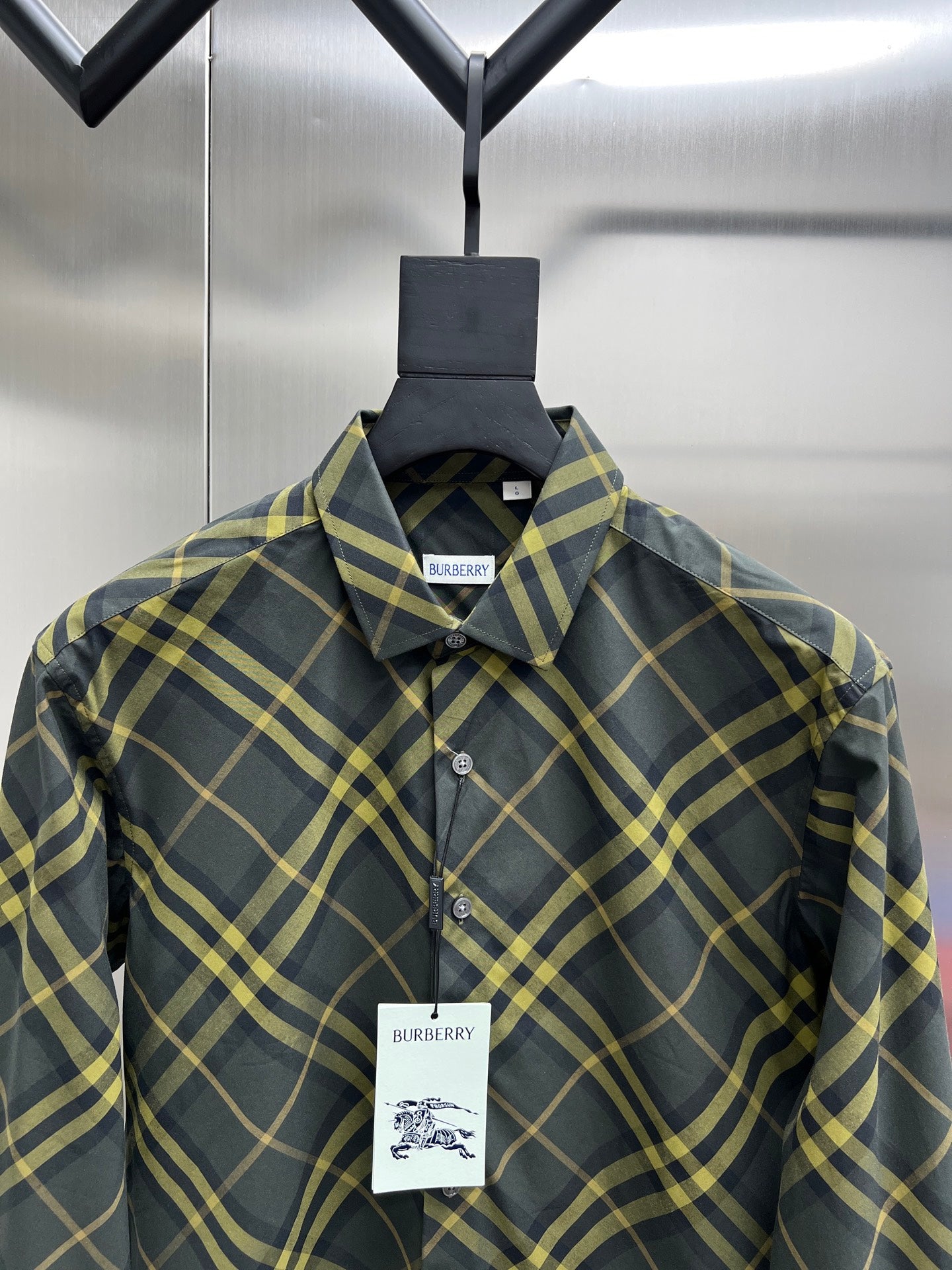 Plaid long-sleeve button-up shirt with pointed collar and chest logo tag
