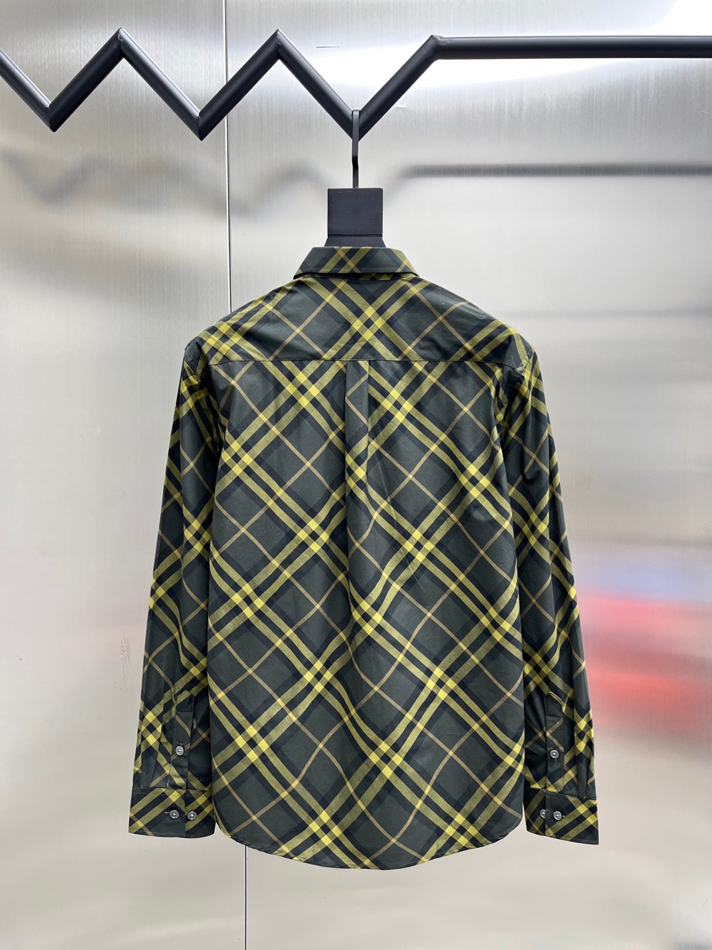 Plaid long-sleeve button-up shirt, back view with yoke seam and hanging tag