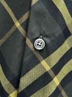 Plaid shirt front with round button and dark blue-green and yellow grid pattern