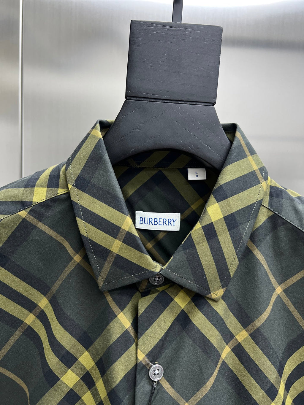 Plaid long-sleeve button-up shirt collar close-up with Burberry label