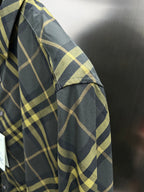 Plaid shirt sleeve close-up with textured fabric and button cuff