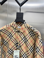 Burberry plaid shirt with point collar, buttons, and chest brand label