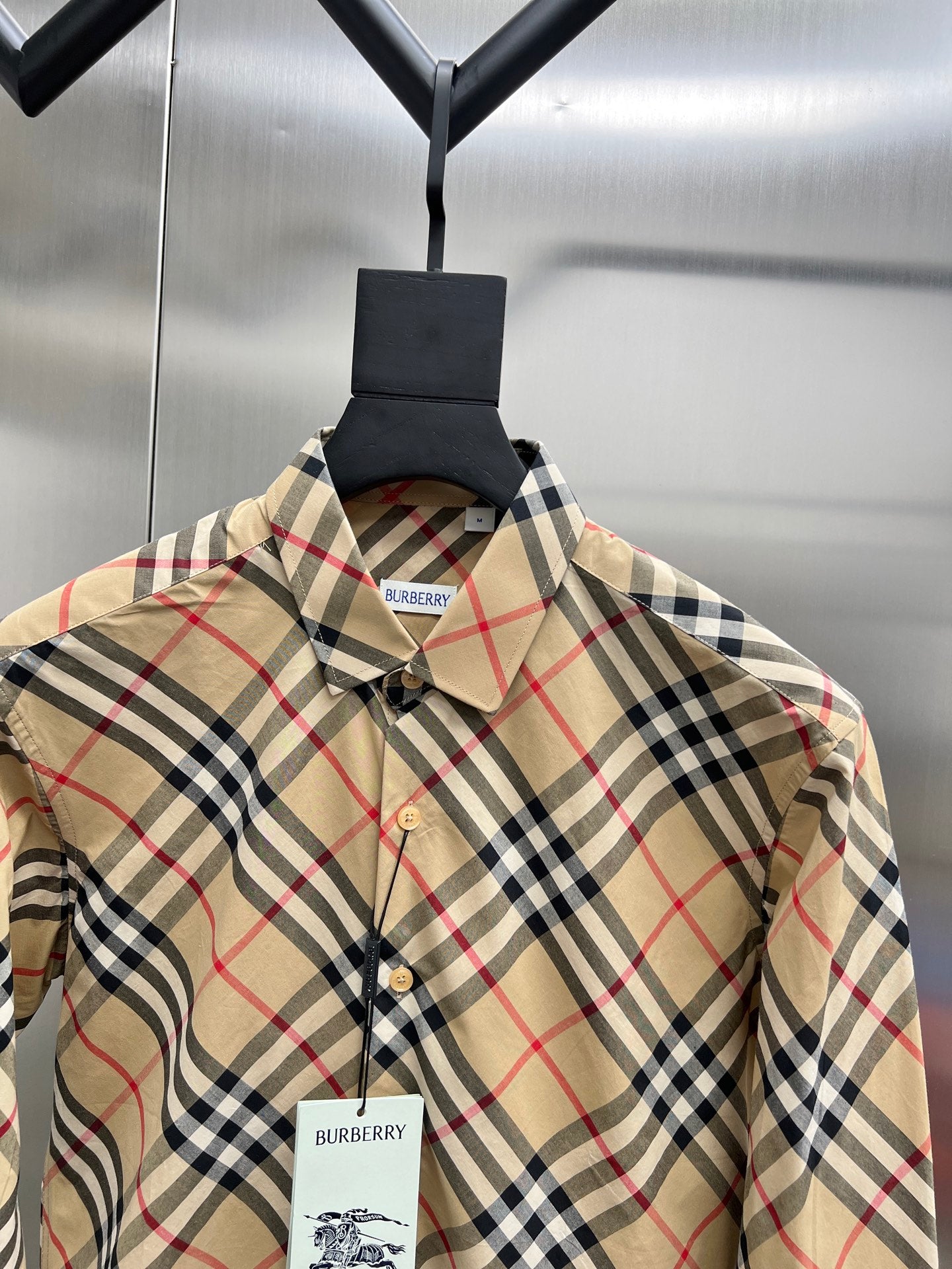 Burberry plaid shirt with point collar, buttons, and chest brand label