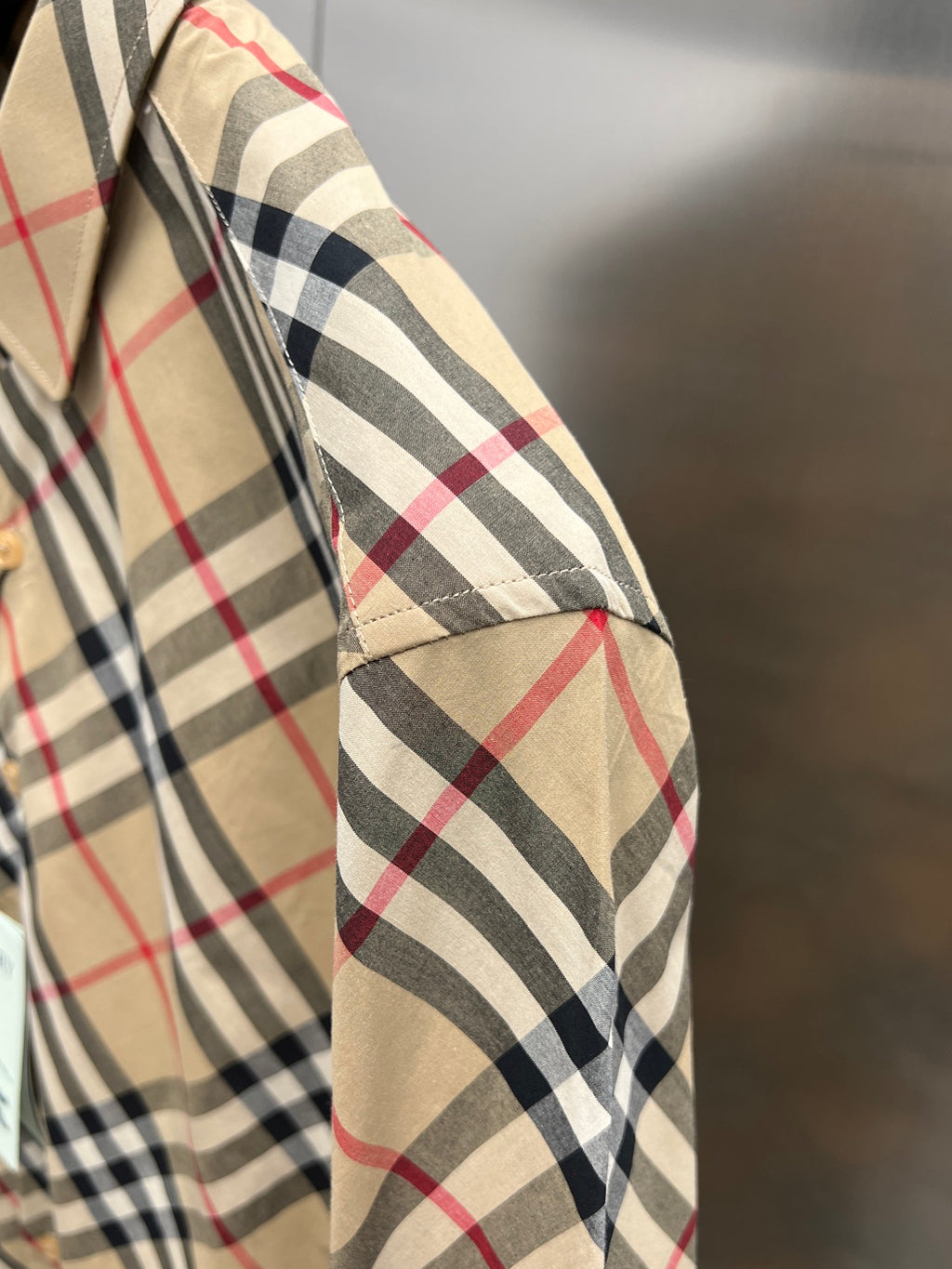 Burberry plaid long-sleeve shirt cuff detail in beige, black, and red