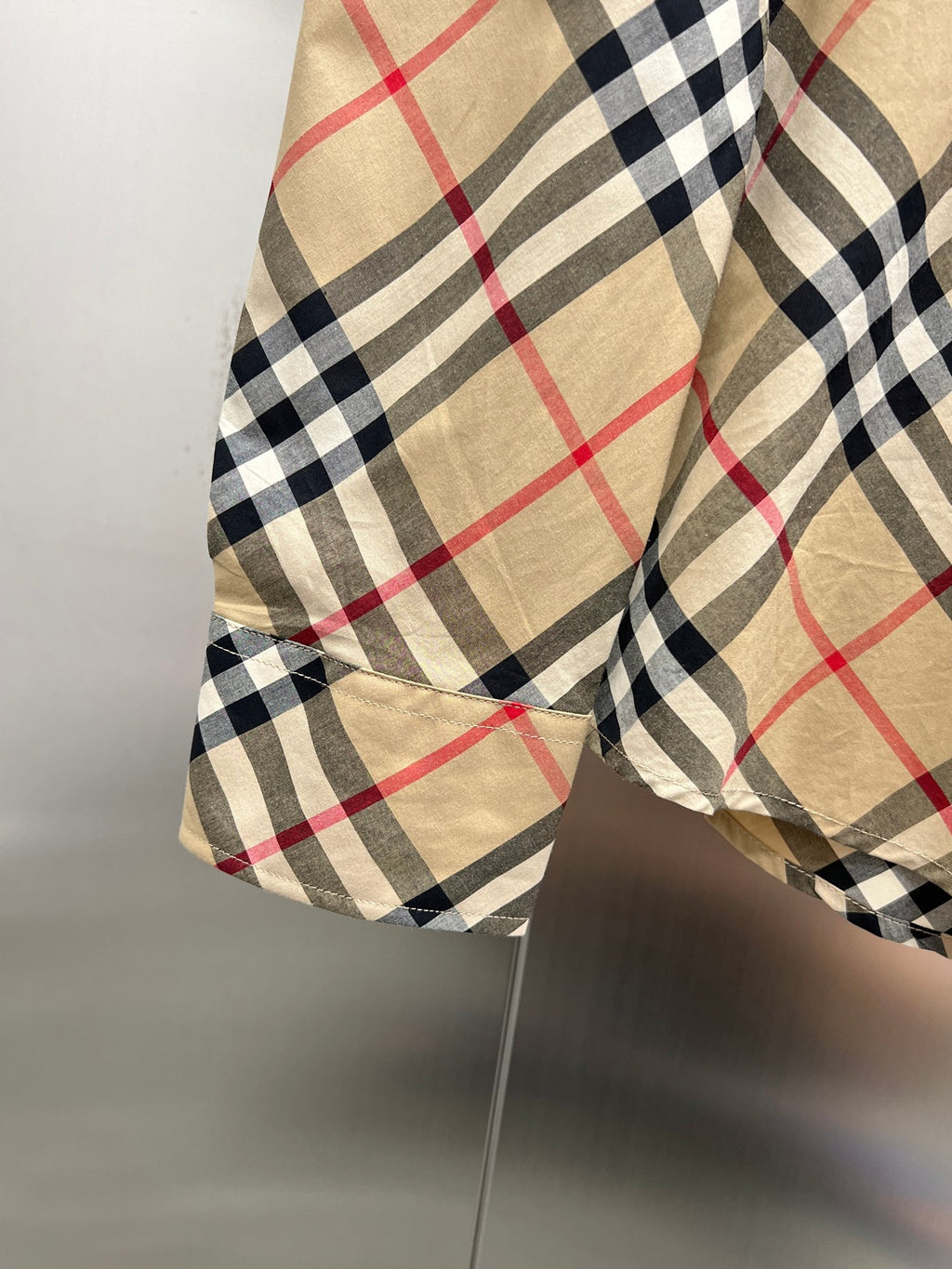 Burberry plaid shirt sleeve with cuff and hem detail on hanger