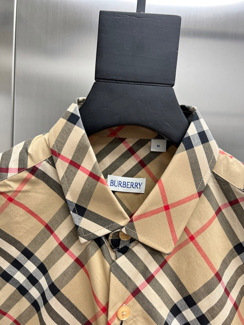 Burberry plaid shirt neckline with button placket and beige collar