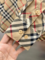 Burberry plaid button-up shirt cuff close-up with beige, red, and navy checks