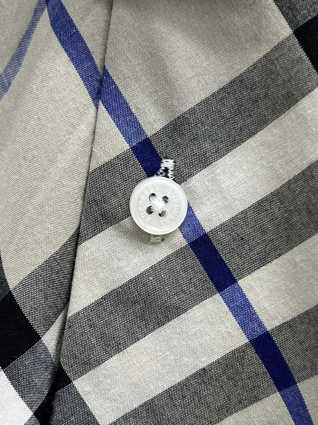 Burberry shirt button detail on blue black and white check plaid