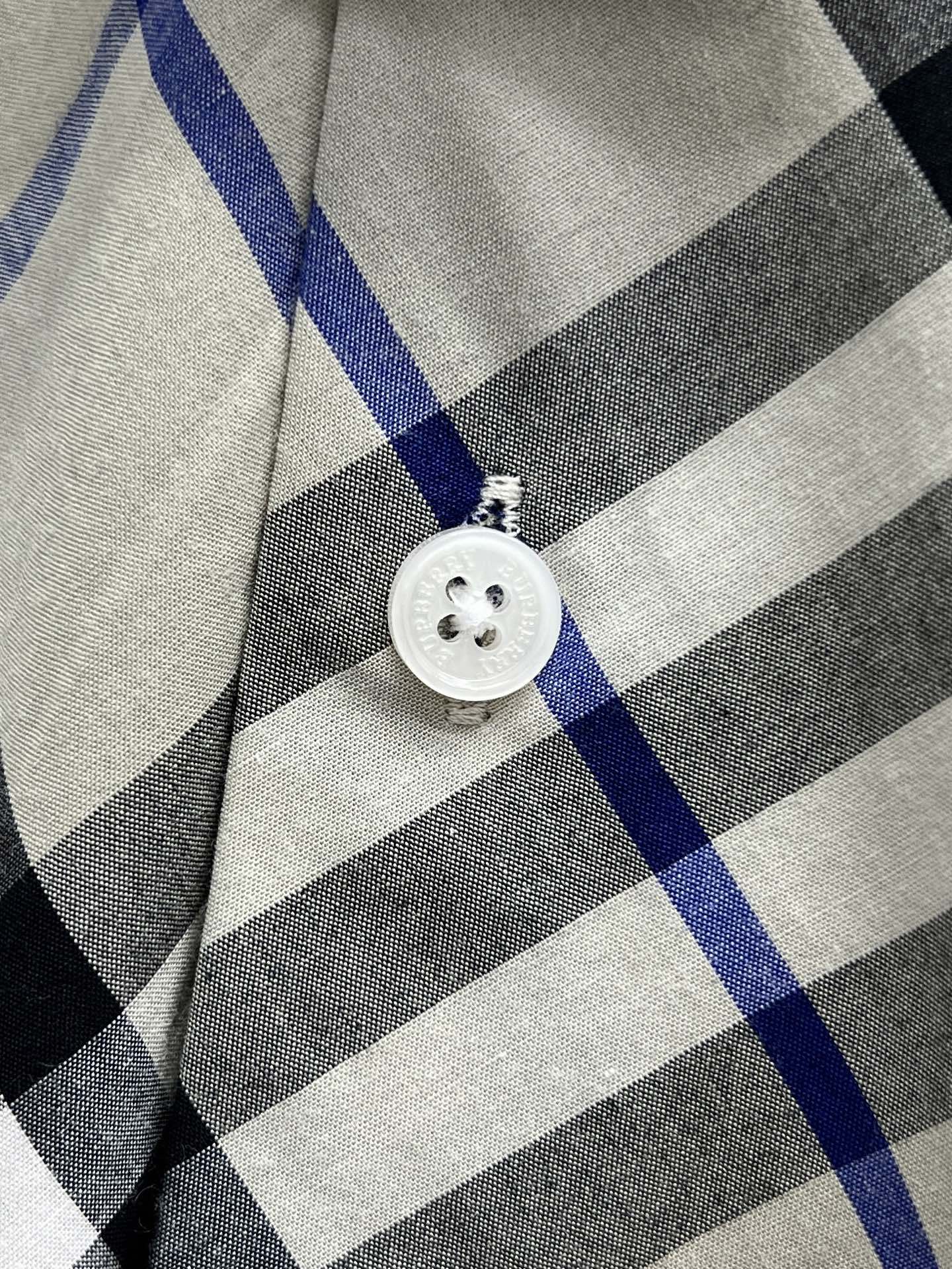 Burberry shirt button detail on blue black and white check plaid