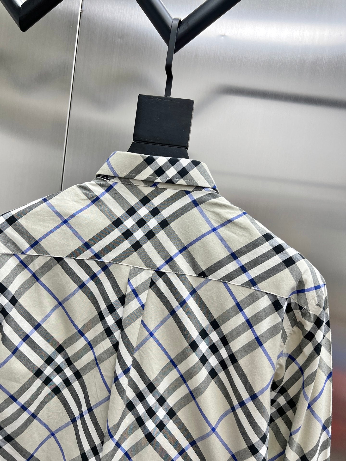Checkered long-sleeve shirt on hanger with back yoke seam
