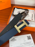 Blue leather belt with gold H buckle, showing strap length and keeper.