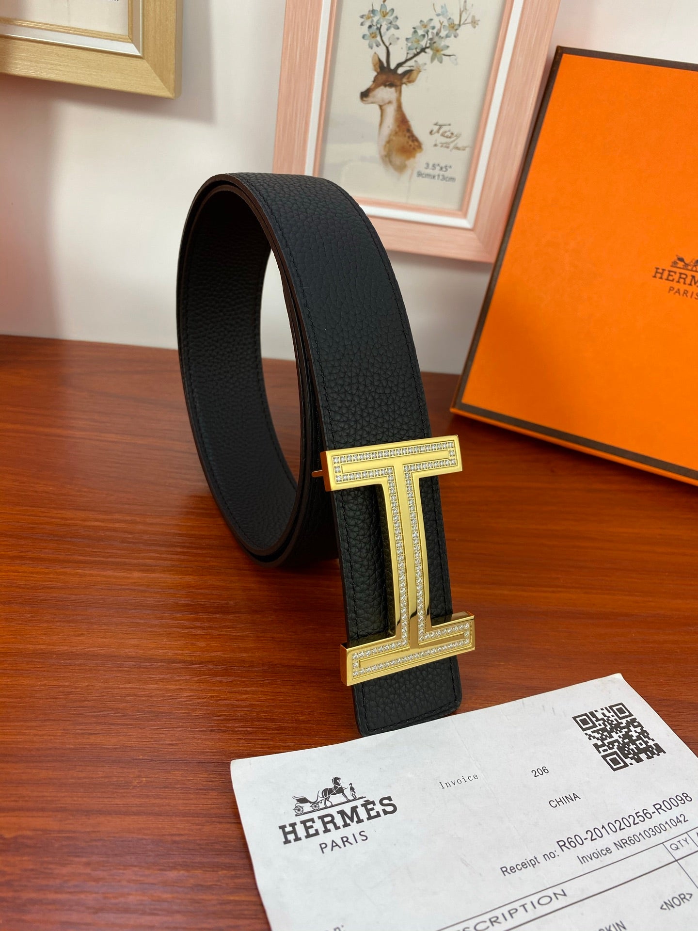 Black leather belt with gold-tone H buckle, upright side angle