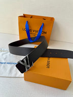 Louis Vuitton belt with dark strap and silver-tone zebra LV buckle