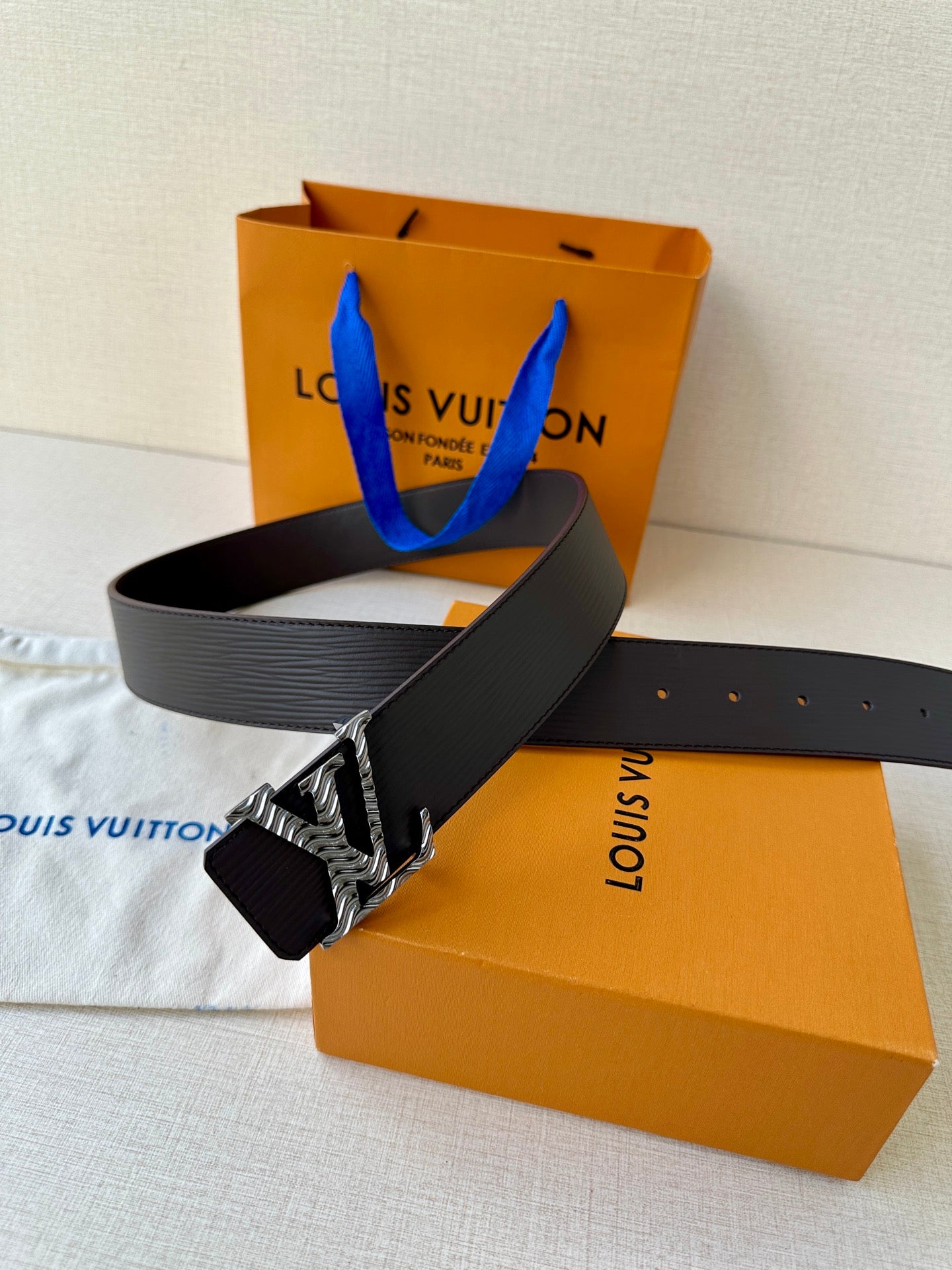 Louis Vuitton belt with dark strap and silver-tone zebra LV buckle