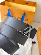 Louis Vuitton belt with dark textured strap and zebra-style LV buckle