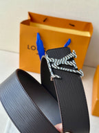 Louis Vuitton belt close-up: dark textured strap and silver-tone zebra LV buckle