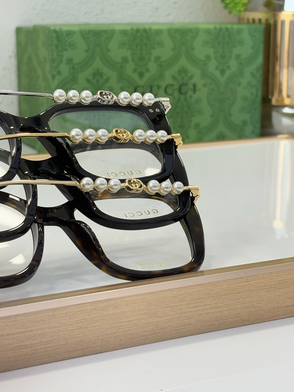 Gucci glasses with black frames and pearl-bead and gold accent temple detail